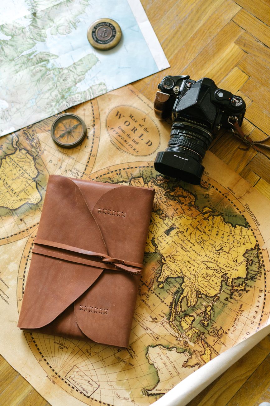 Vintage map and travel camera on wooden table